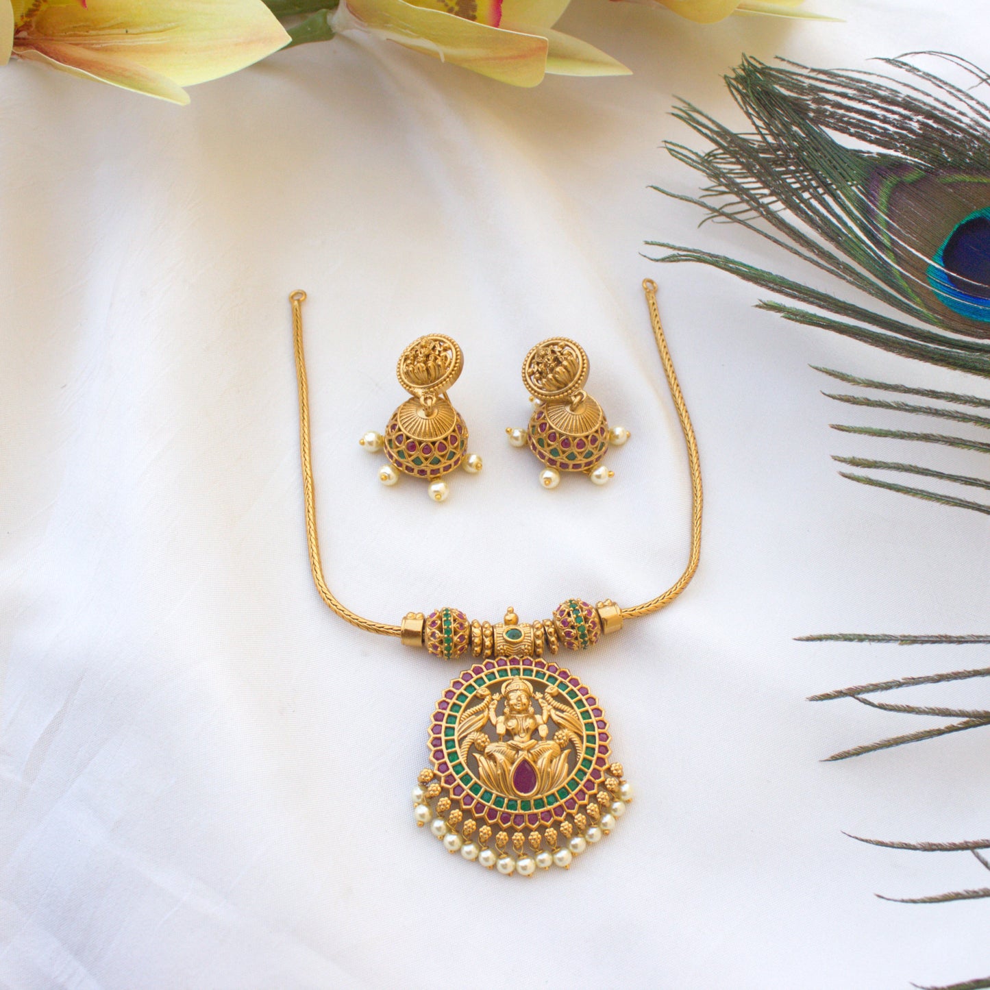 Gold Look AD Lakshmi Pendant Chain Necklace Set - Red and Green